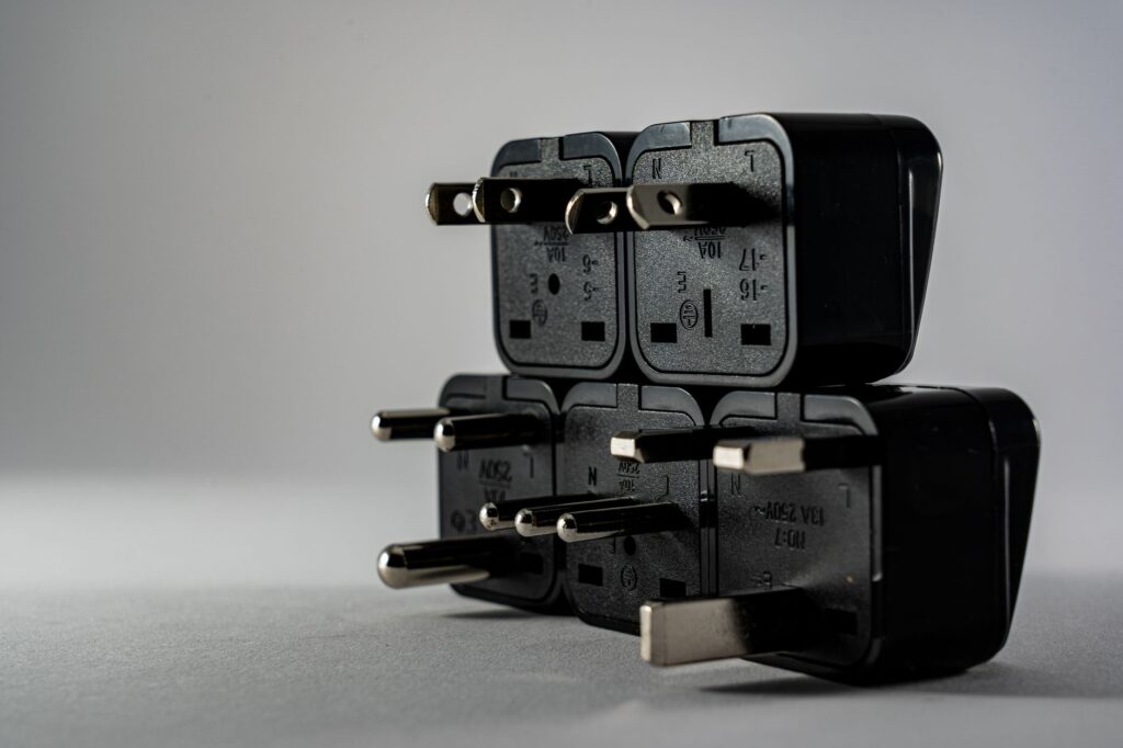 An adapter joining two different plug types, representing a protocol layer between a model and existing APIs